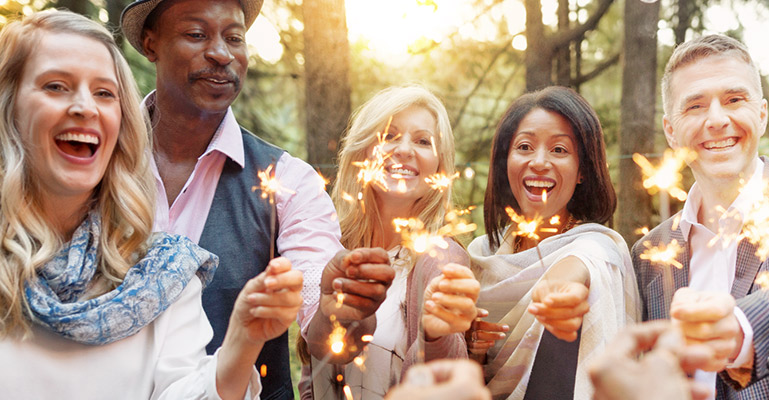 Smiling people with sparklers